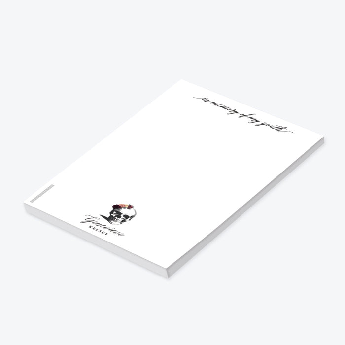 A white notepad with an illustration of a skull wearing a flower crown, and text that reads 'In Memory of my Youth'. The notepad is customizable with a name and has a subtitle 'Death to my 20s Birthday Party Favor Pad'.