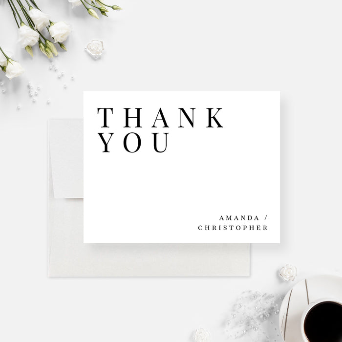 Minimalist white wedding thank you card with spaced black typography and personalized couple names.