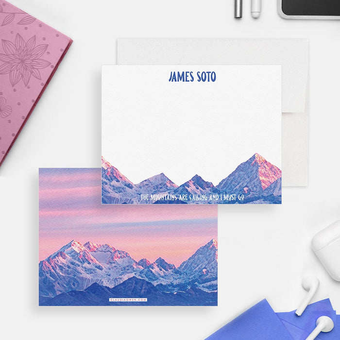 Mountain note cards with a personalized name and adventure quote on the white front; pink sunset and blue mountain peaks across the back.