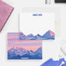 Mountain note cards with a personalized name and adventure quote on the white front; pink sunset and blue mountain peaks across the back.